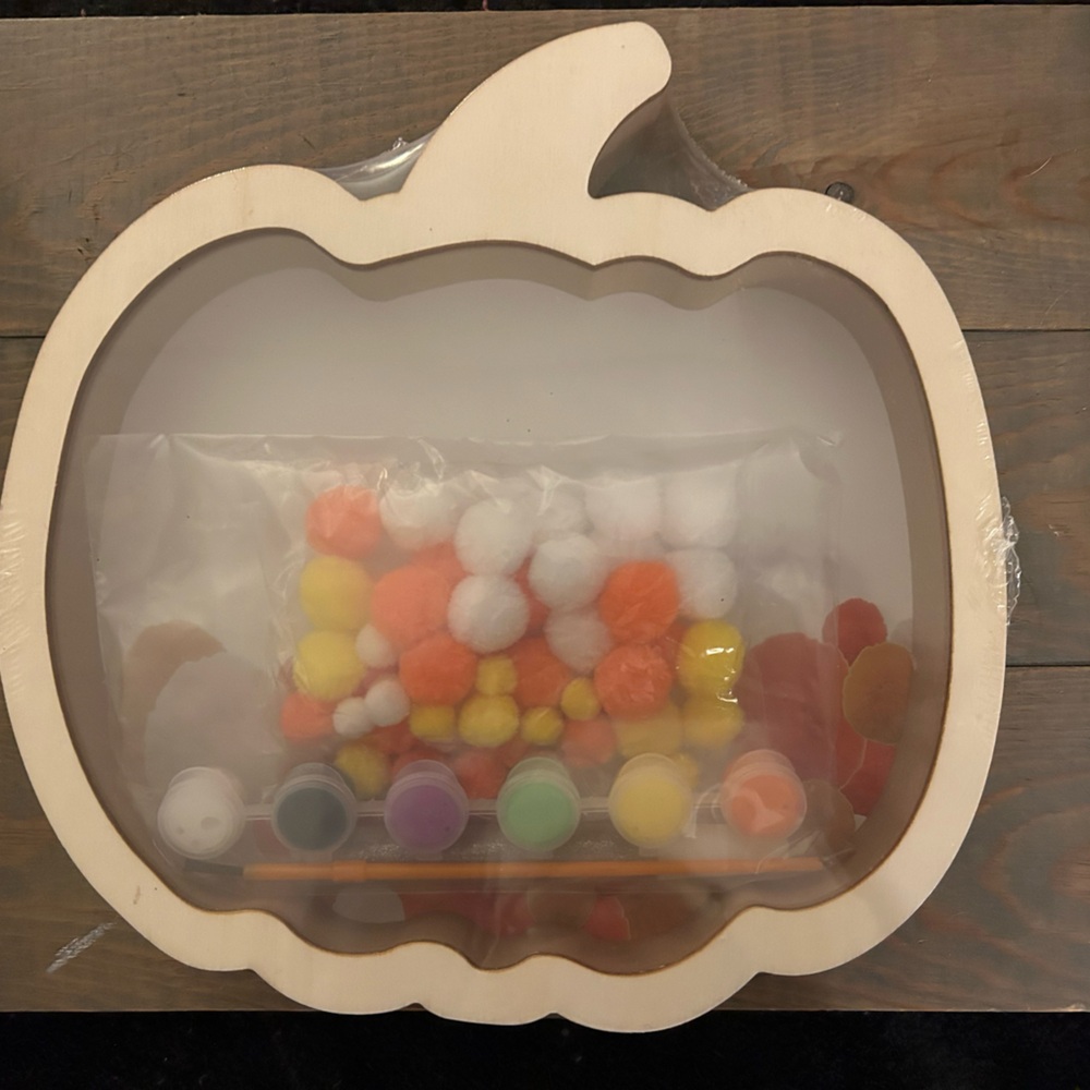 Wood pumpkin shadow box craft with paint and pom poms